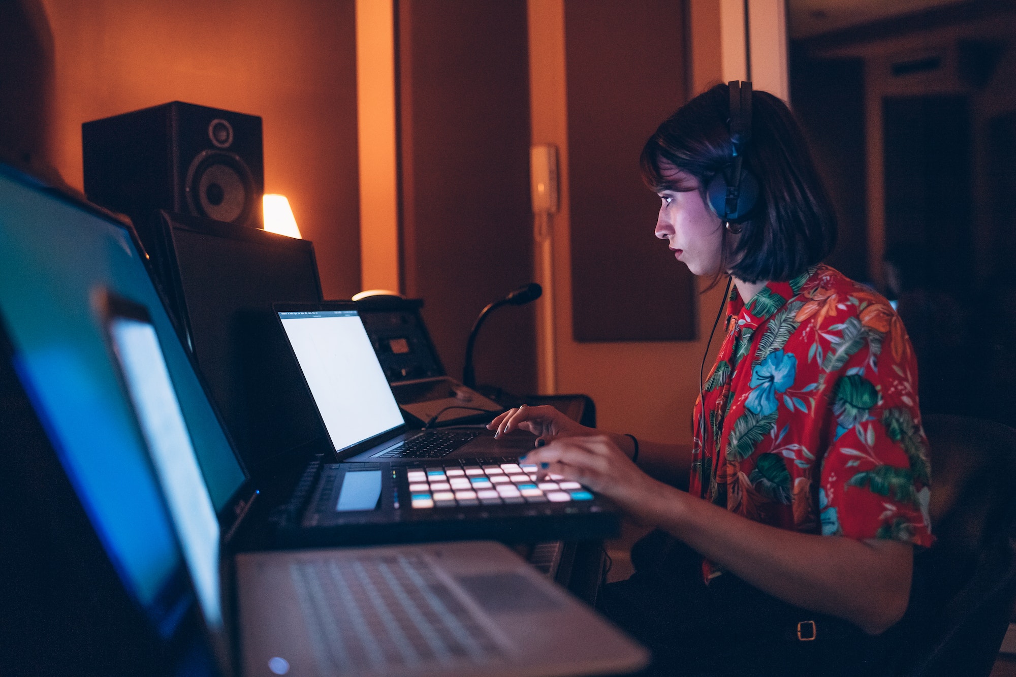 Young woman dj using mpc pad